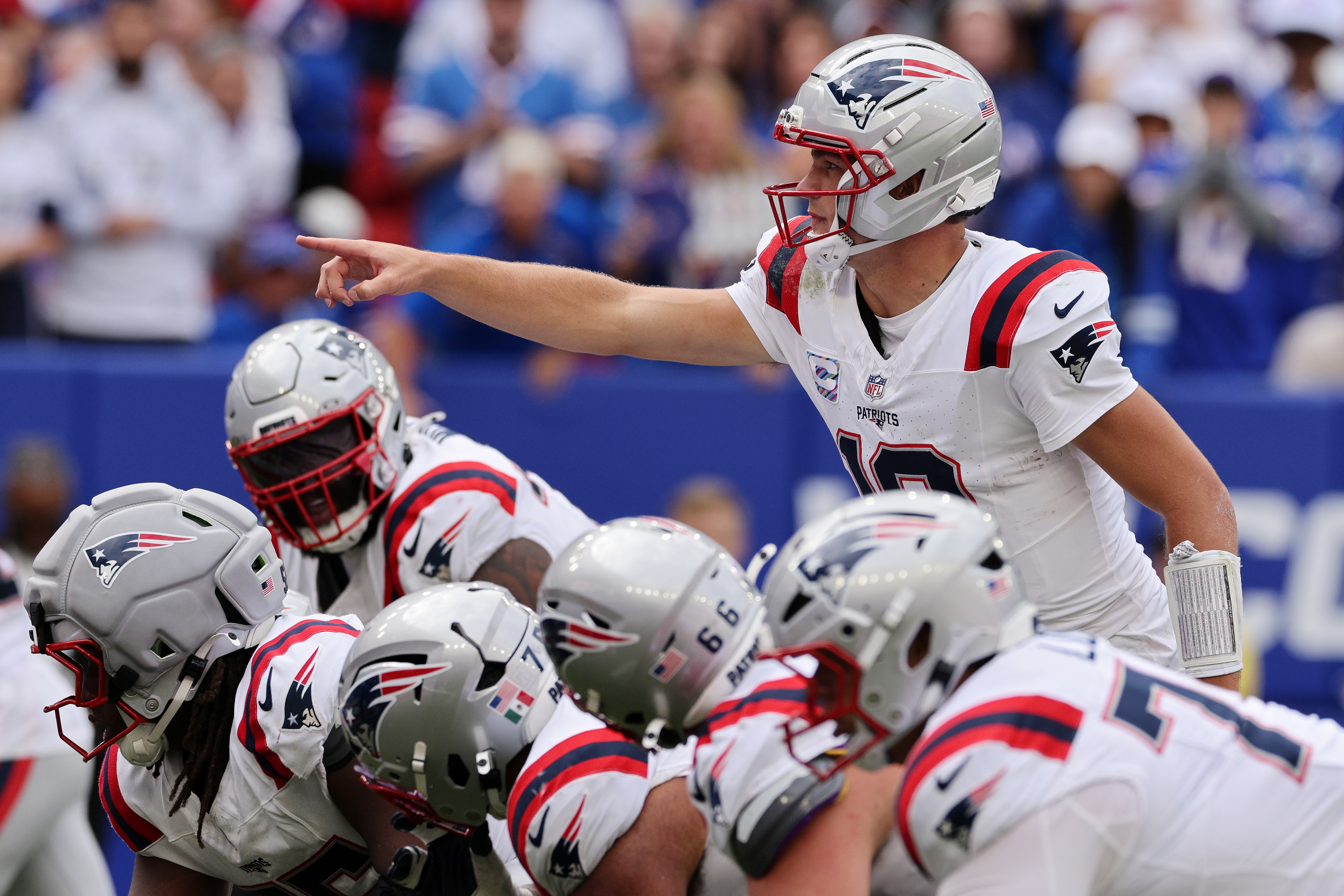 ORCHARD PARK, NEW YORK - OCTOBER 04: Drake Maye #10 of the New England Patriots calls a play at the line of scrimmage against the Buffalo Bills during the third quarter at Highmark Stadium on October 04, 2026 in Orchard Park, New York.