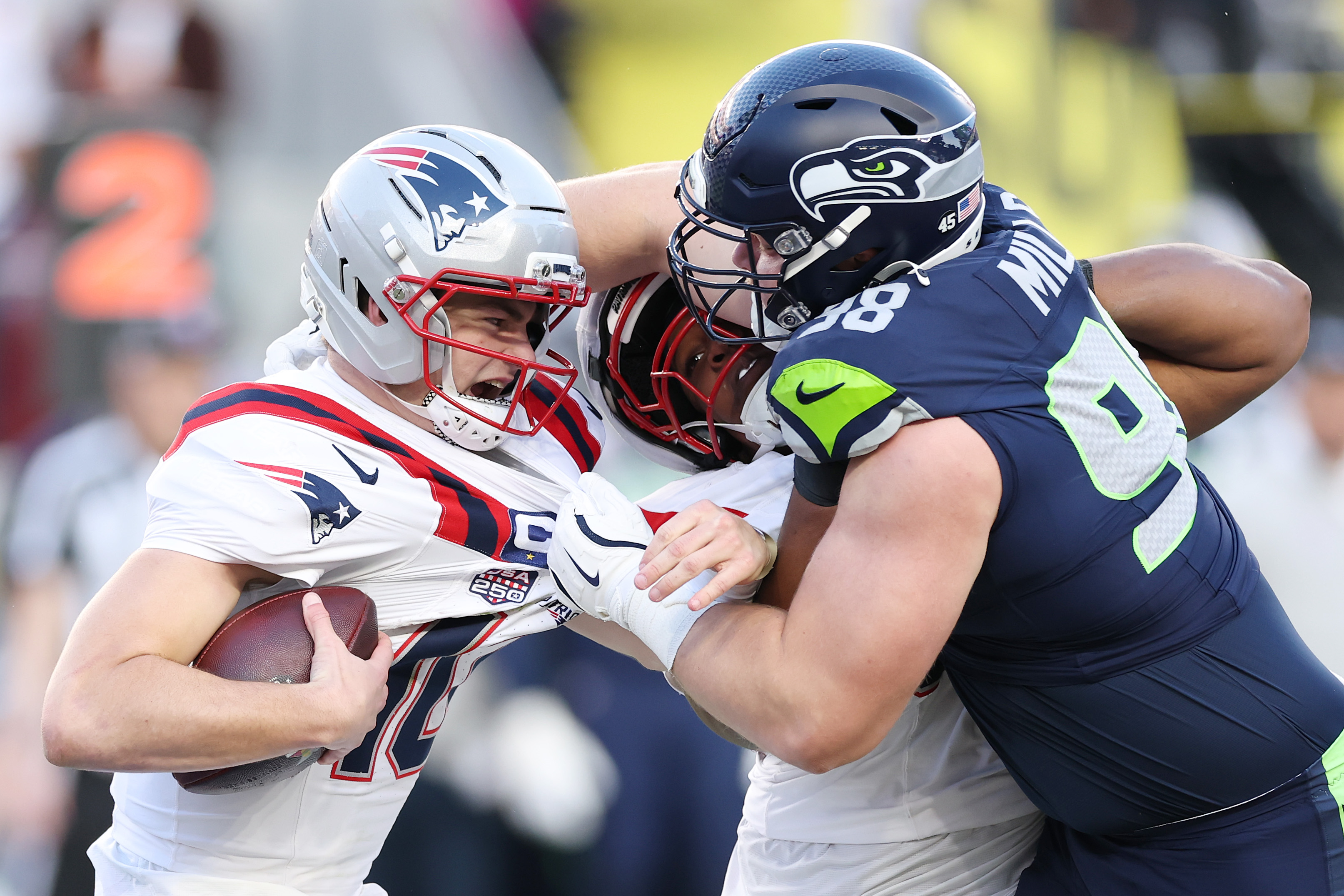 SANTA CLARA, CALIFORNIA - FEBRUARY 08: Drake Maye #10 of the New England Patriots is sacked by Rylie Mills #98 of the Seattle Seahawks during the second quarter in Super Bowl LX at Levi's Stadium on February 08, 2026 in Santa Clara, California.